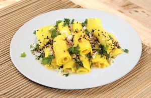 Plate of Khandvi with mustard seed tadka and chutney